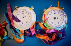 Family-Festival-2025-Time-Plates Paper plates with hand-drawn clock faces and colourful ribbons